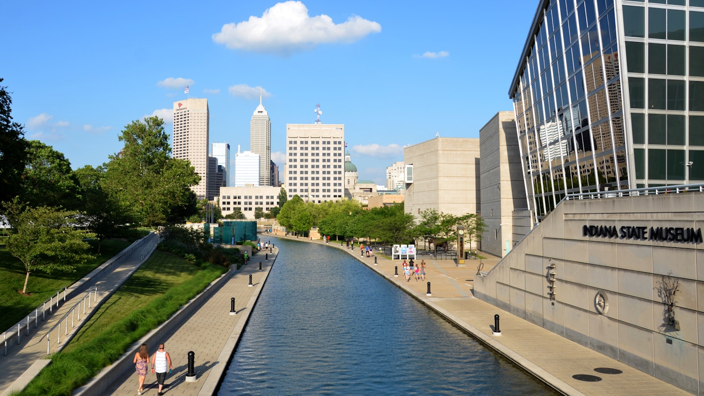 Indianapolis, IN, USA - June 17, 2014: Indianapolis skyline seen from Canal Walk near the Indiana State Museum June 17, 2014. The three mile loop is a popular walking and jogging trail in downtown Indianapolis.
